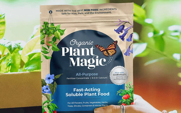 Close up of soluble plant food packaging with plants in background